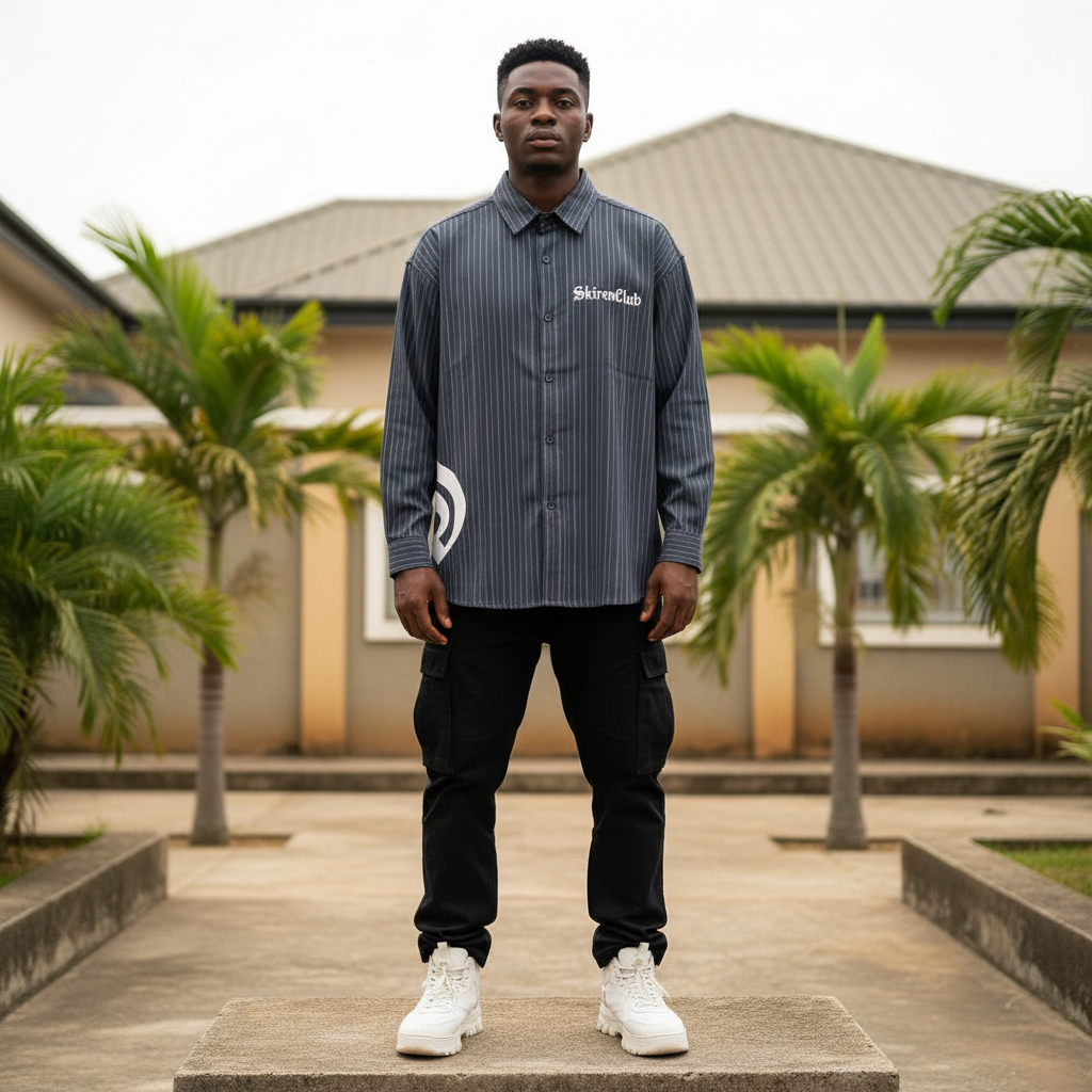 Nigerian male model wearing navy striped oversized gothic graphic long-sleeve shirt – full body lifestyle shot