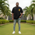 Nigerian male model wearing black pop-art streetwear character graphic tee – front view