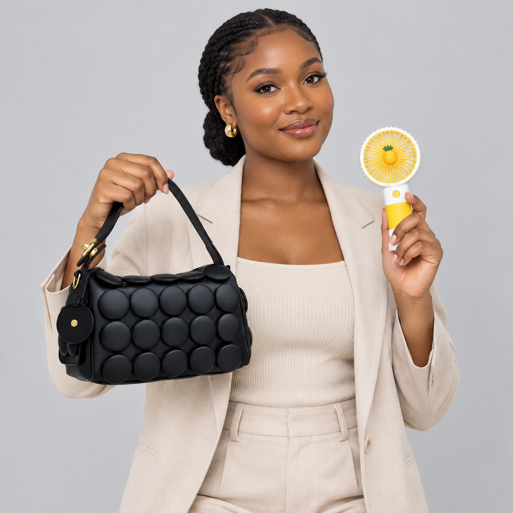 Nigerian woman carrying black circle-appliqué shoulder bag and holding yellow handheld fan