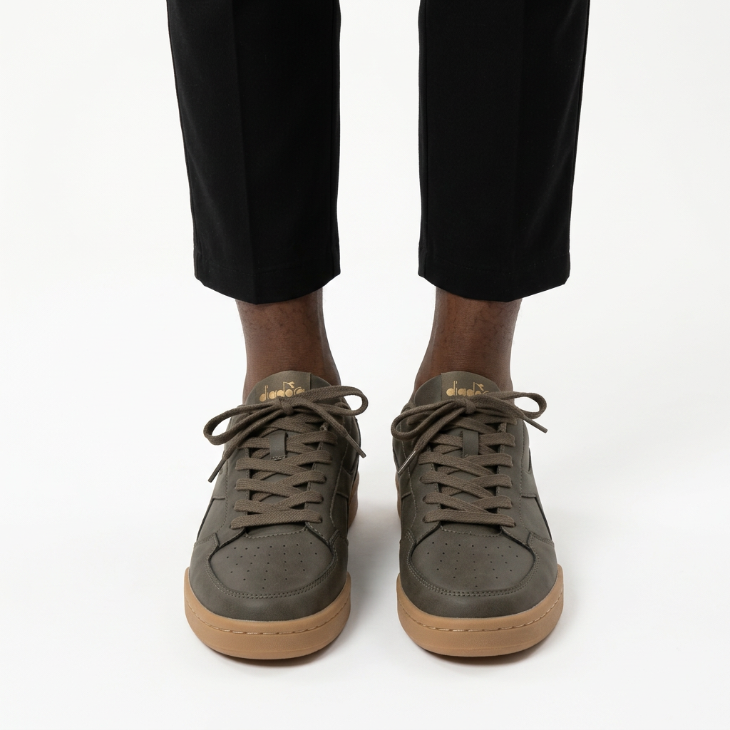 Adult man wearing olive-green trainers with gum soles
