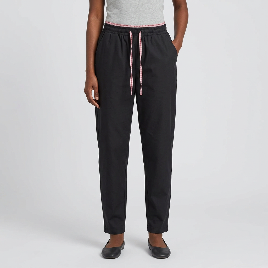 Black trousers with pink drawstring detail worn by an adult model