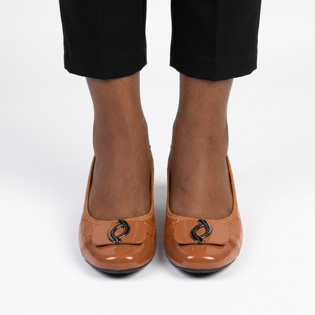 Adult woman wearing cognac oval-detail wedges with feet together