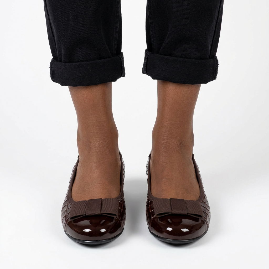 Adult woman wearing dark brown bow wedge shoes
