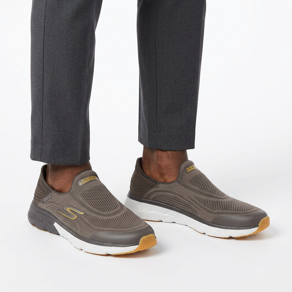 Model wearing men's taupe-grey mesh slip-on trainers with white midsoles and gum tread
