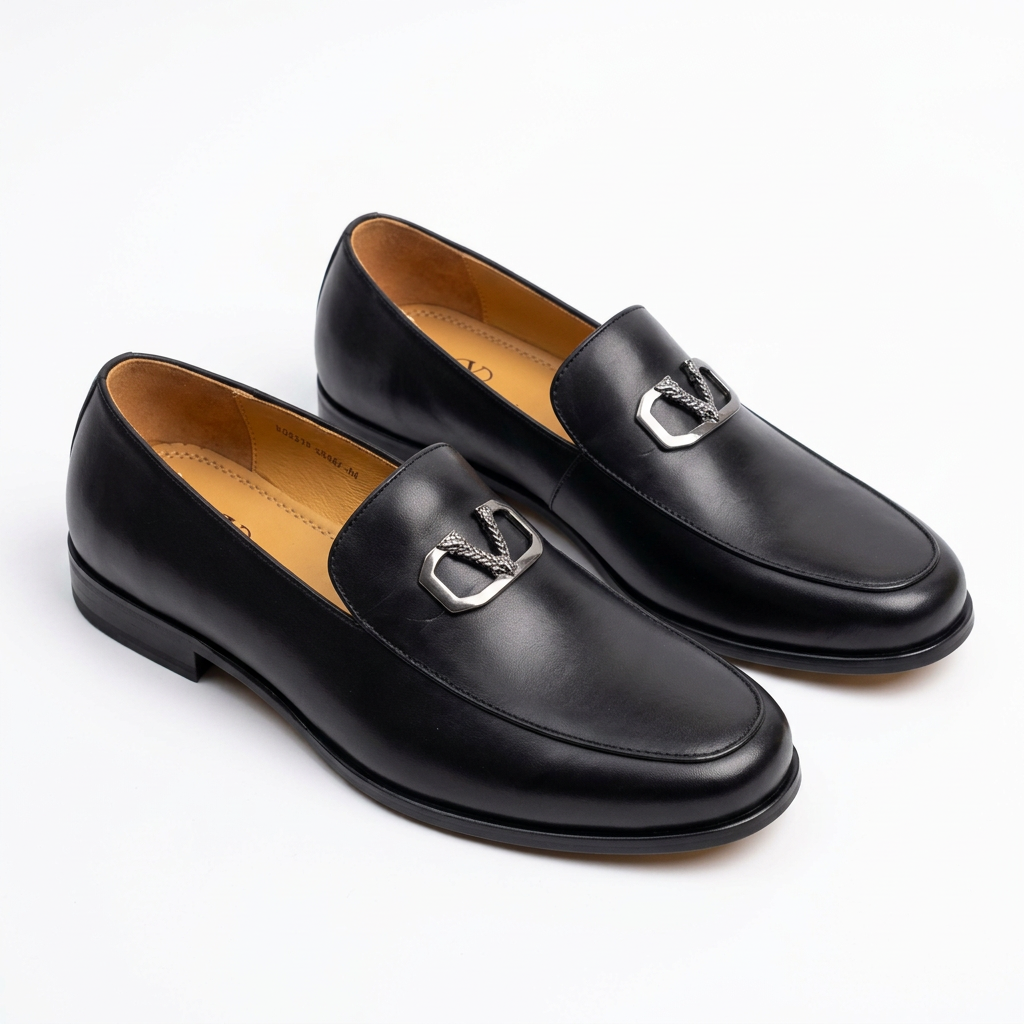 Pair of smooth black silver-detail loafers on white