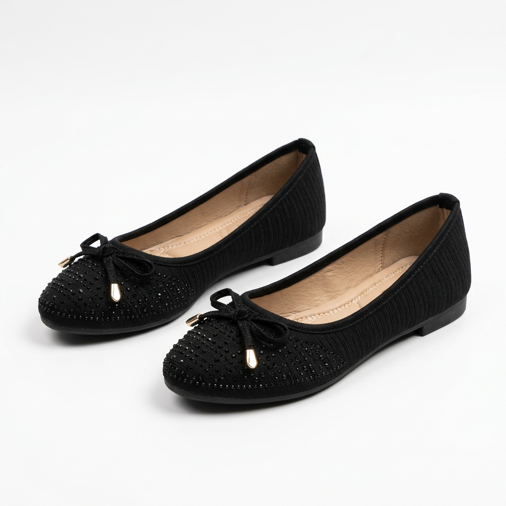 Complete pair of black textured cord-bow ballet flats resting on a white floor