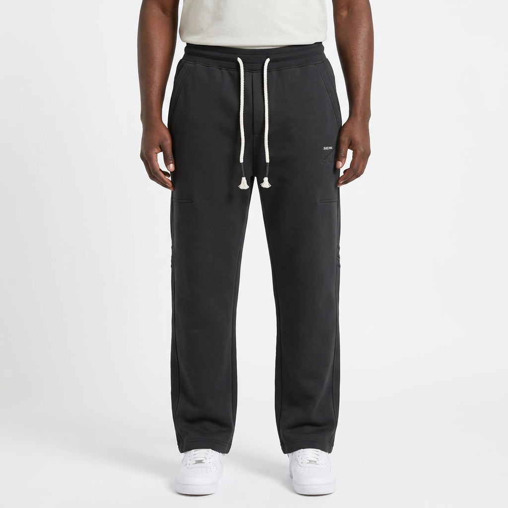 Adult Black model wearing charcoal grey straight-leg joggers with white rope drawstrings