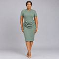 Black Nigerian woman wearing a sage-green ruched midi dress