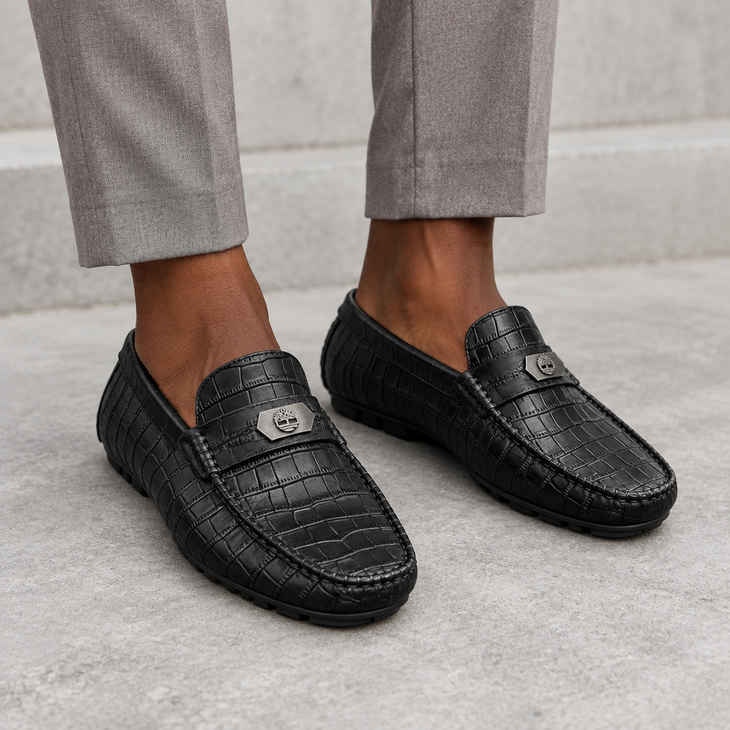 Black textured loafers worn on both feet