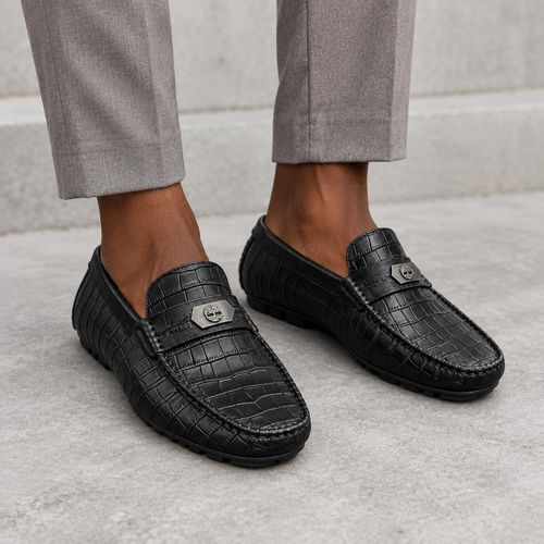 Black textured loafers worn on both feet