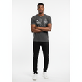 Young Nigerian male wearing dark charcoal SPCC Denim DVSN Modern Soldier graphic tee