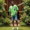 Nigerian male model wearing lime green oversized Authentic label tee in streetwear style