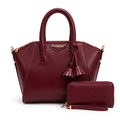 Burgundy twin-handle handbag with tassel details pictured with matching zip wristlet