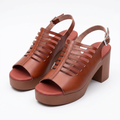 Pair of rust caged platform block-heel sandals on white background