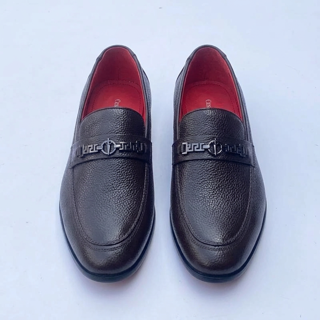 Straight-on black textured loafers with geometric hardware and red lining