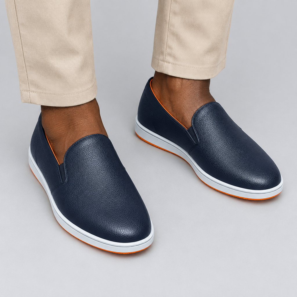 Dark navy slip-on shoes worn with beige trousers