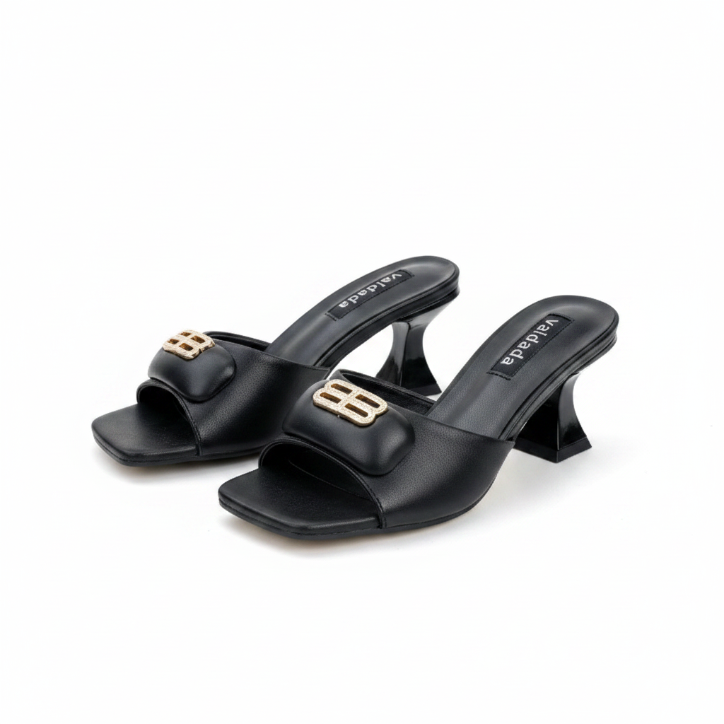Ghost mannequin pair view of black leather sculptural block heel mules with gold logo hardware