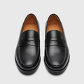 Men's black leather penny loafers, straight-on view of the pair
