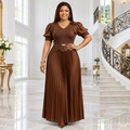 Black Nigerian woman wearing chocolate brown pleated occasion dress