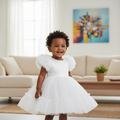 Young Nigerian baby girl wearing white puff sleeve tulle dress