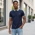 Young Nigerian male model wearing navy and sage green colorblock polo shirt