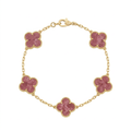 Gold-tone bracelet with five pink clover charms on white