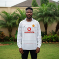 White long-sleeve retro football jersey with red and black pinstripes — Nigerian male model front view