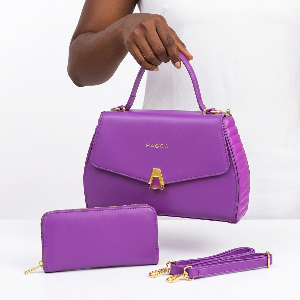Hand holding a purple gold-clasp handbag with matching wallet and strap
