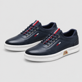Pair of dark navy lace-up shoes with white soles