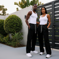 Nigerian male and female models wearing unisex black wide-leg jogger trousers, clean 1:1 square, no attachment