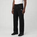 Model wearing black stud-trim wide-leg jeans