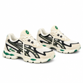 Cream mesh sneaker pair with dark overlays and green accents on white background