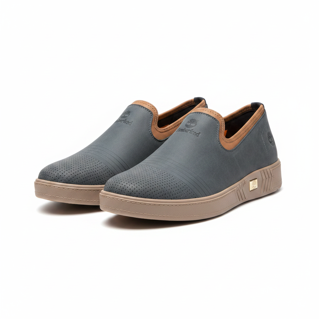Men's slate blue nubuck leather slip-on sneakers with tan collar trim pair product shot