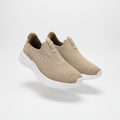 Beige knit slip-on sneakers with white sole, centred on a plain off-white background