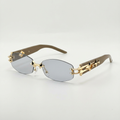 Light smoke rimless glasses with gold-tone link details and taupe-brown arms
