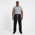 Adult Black model wearing black joggers with white side stripes and drawstrings