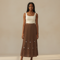 Nigerian girl wearing caramel brown bow pleated midi skirt - front view