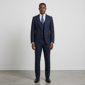 Full-body Black adult model wearing a dark navy three-piece suit