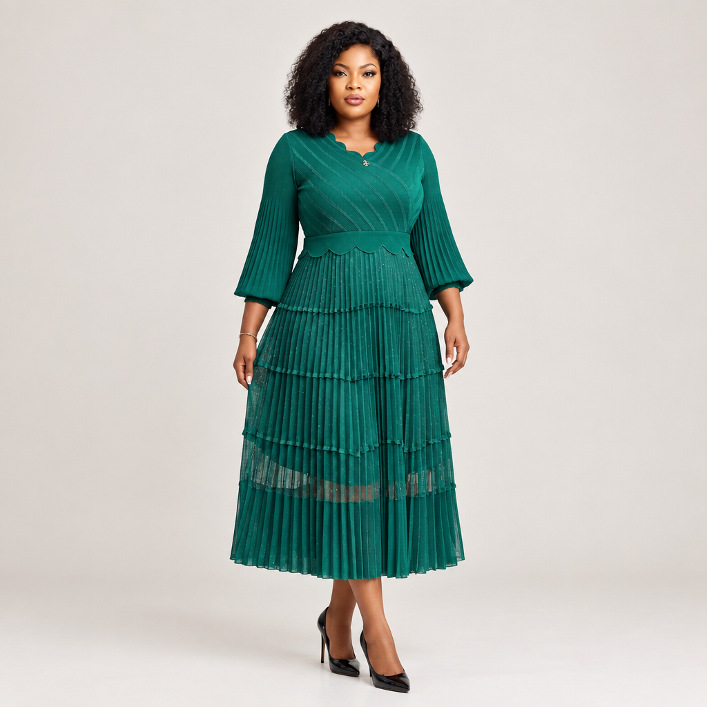 Black Nigerian model wearing an emerald tiered pleated gown with bell sleeves