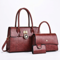 Wine three-piece set with two top-handle handbags and snap wallet on a white background