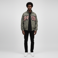 Man wearing the washed grey varsity patch bomber jacket