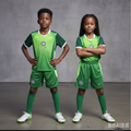 Black Nigerian boy and girl wearing the exact green and neon lime football jersey and shorts set