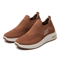 Pair of brown knit slip-on sneakers on white