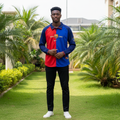 Royal blue and red split long-sleeve centenary retro football jersey — Nigerian male model front view