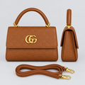 Cognac brown embossed handbag front and side views with matching strap