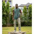 Nigerian male model wearing washed teal distressed oversized sleeveless vest – full body lifestyle shot