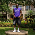 Nigerian male model wearing men's black gothic script rhinestone stud denim shorts streetwear style