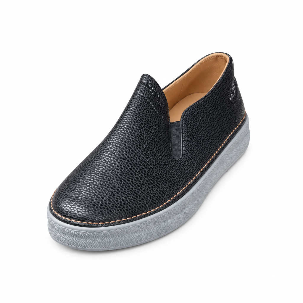 Black textured slip-on shoe with elastic side panel and grey sole