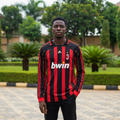 Black and red striped long-sleeve retro football jersey — Nigerian male model front view