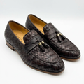 Pair of dark brown basket-weave tassel loafers on white